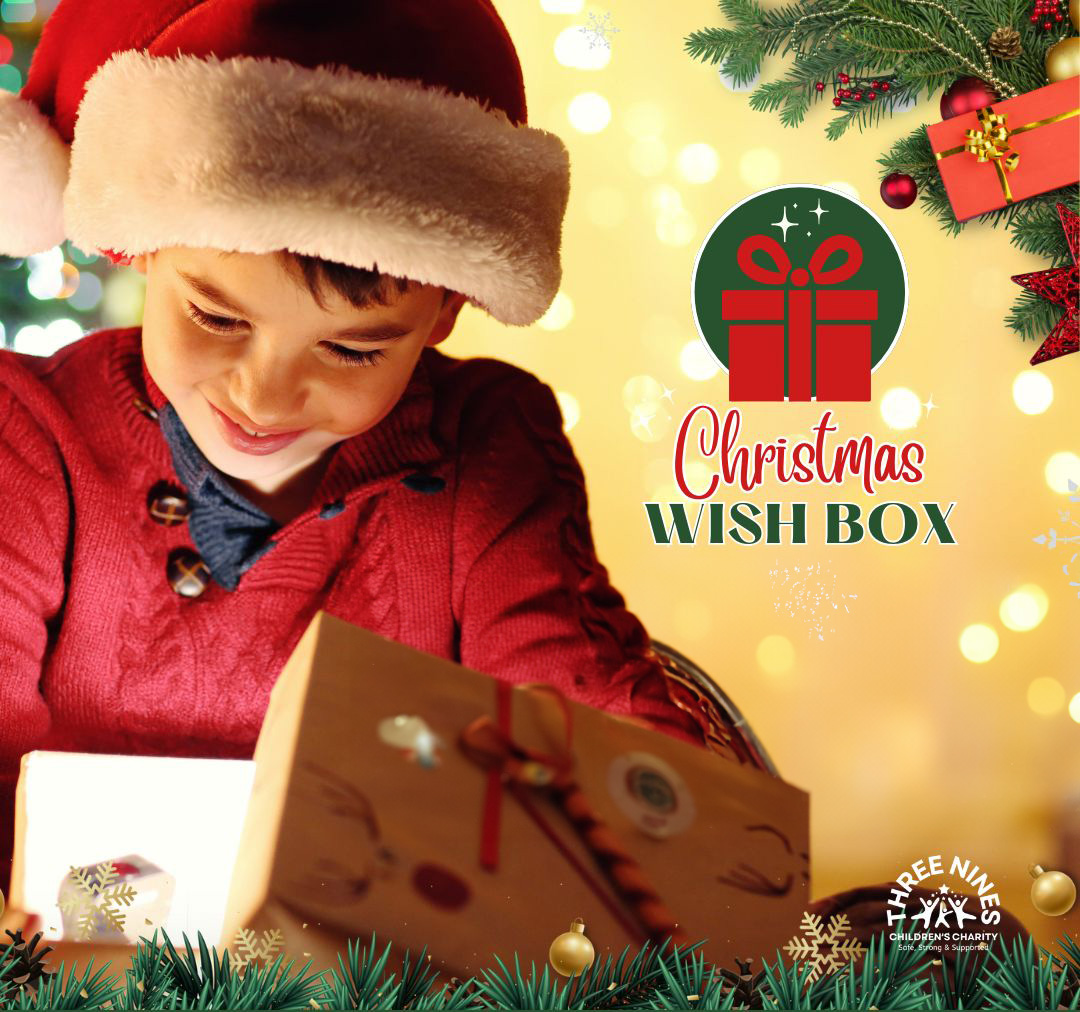 Boy opening presents - Christmas Wish Box - Three Nines Children's Charity